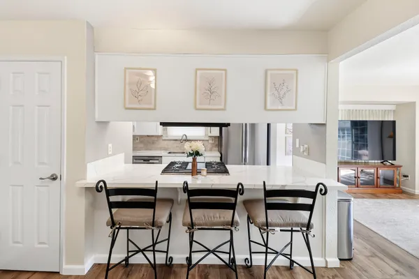 a kitchen with stainless steel appliances granite countertop a stove and a refrigerator
