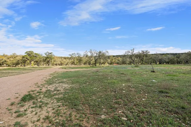 a view of a field with an ocean