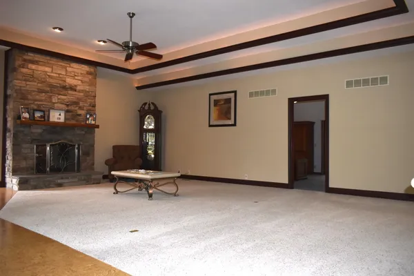 a view of a big room with windows and chandelier