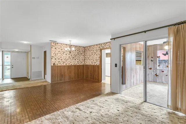 a view of a big room with a large window and front door