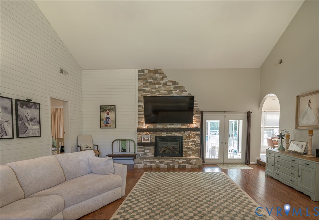12700 Coalboro Road Chesterfield, VA 23838 - Photo 18 of 50 Vaulted ceiling living room featuring a stone-clad