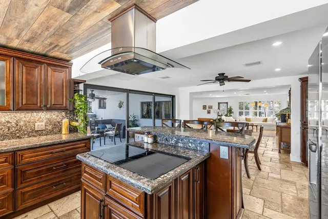 a bathroom with a granite countertop sink a toilet and mirror