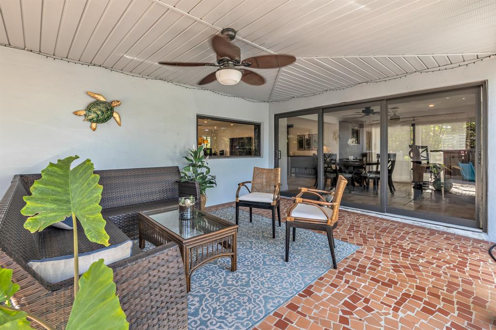 2801 Northeast 48th Court Lighthouse Point, FL 33064 - Photo 20 of 50 a living room with furniture a rug and a chandelier