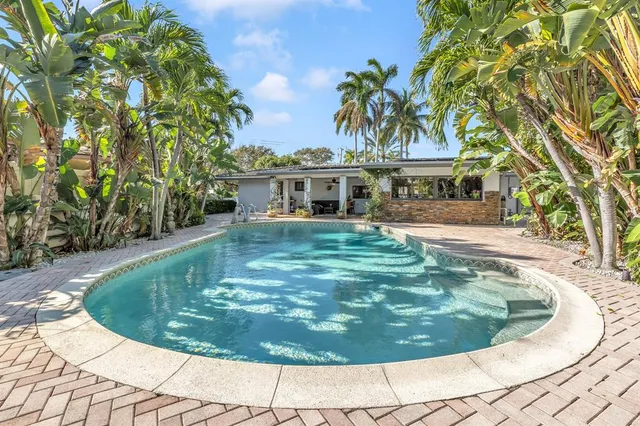 a view of a swimming pool with an outdoor space and sitting area