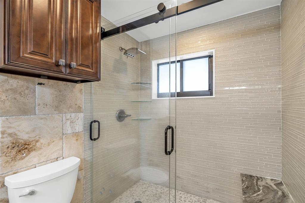 2801 Northeast 48th Court Lighthouse Point, FL 33064 - Photo 30 of 50 a bathroom with a toilet a sink and a shower