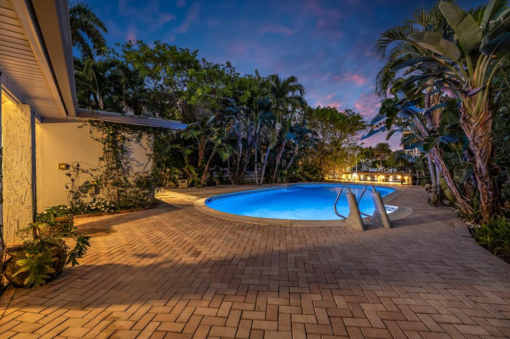 2801 Northeast 48th Court Lighthouse Point, FL 33064 - Photo 42 of 50 a view of a swimming pool with an outdoor space and seating area