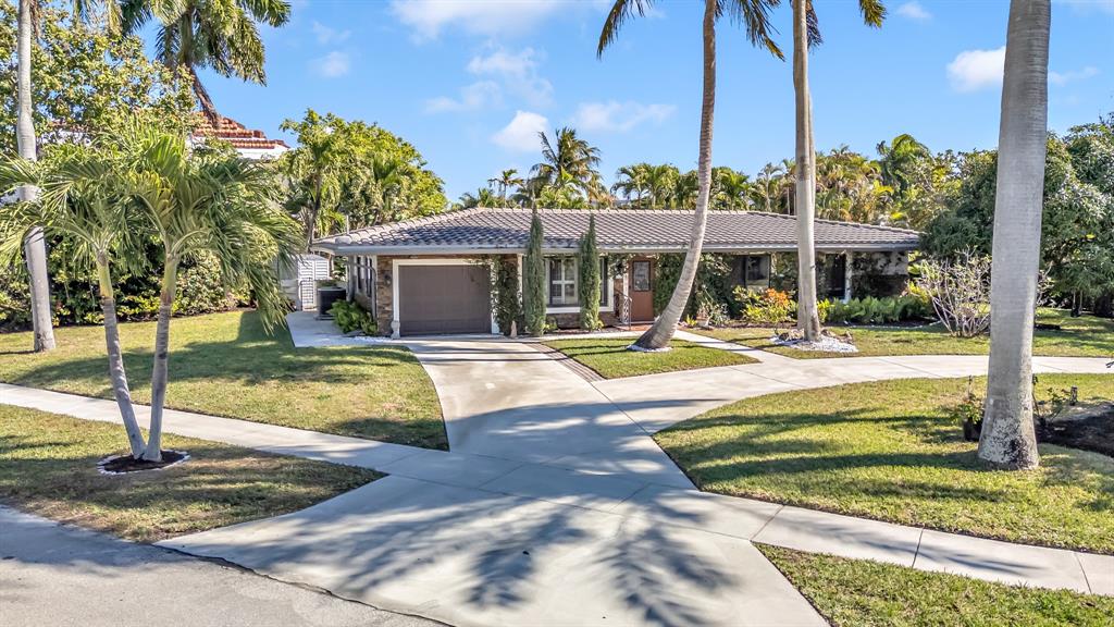 2801 Northeast 48th Court Lighthouse Point, FL 33064 - Photo 6 of 50 a view of a swimming pool with a lawn chairs under palm trees