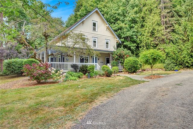 a front view of house with yard and green space