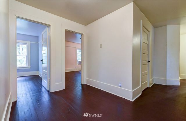 an empty room with wooden floor and closet