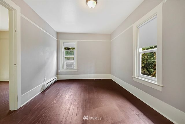 a view of a livingroom with wooden floor and window