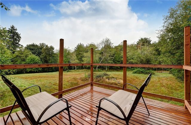 a view of a balcony with wooden floor and outdoor seating