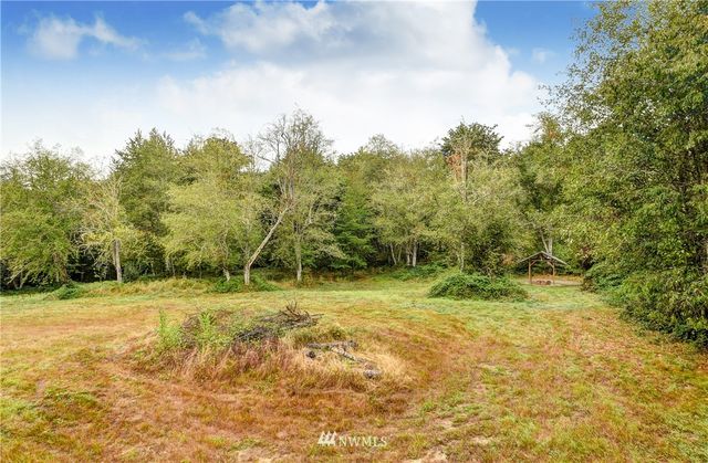 a view of a field with trees in the background
