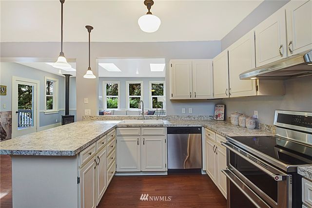 a kitchen with a sink stove and cabinets