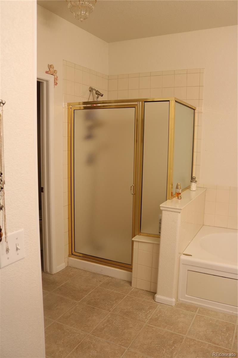 6616 South Reed Way, Unit A Littleton, CO 80123 - Photo 10 of 18 a bathroom with a shower and a tub
