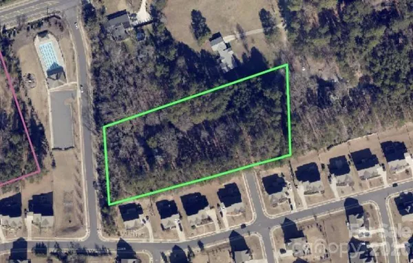 an aerial view of house with yard and mountain view in back
