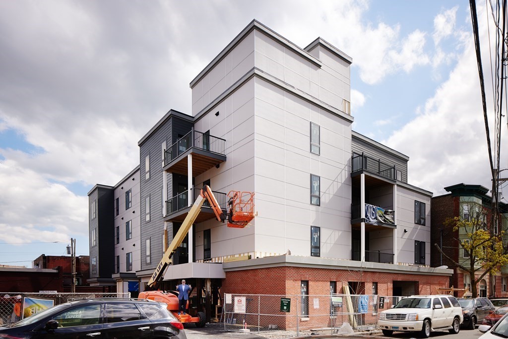 157 Chestnut Street, Unit 203 Chelsea, MA 02150 - Photo 1 of 12 a view of a street with buildings