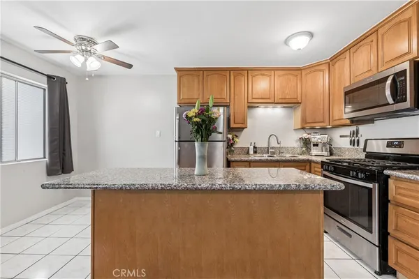 a kitchen with stainless steel appliances granite countertop a sink stove and microwave