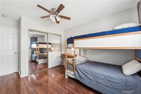 a bedroom with furniture and wooden floor