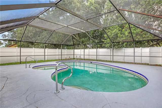 a view of a swimming pool with a in a backyard