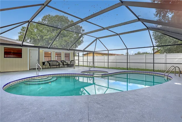 a view of a backyard with a swimming pool