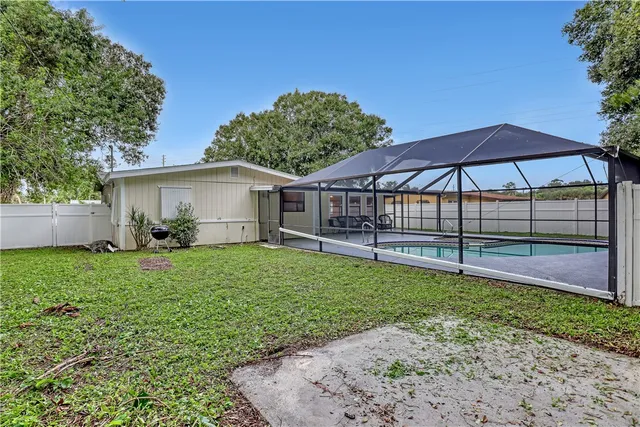 a view of a house with backyard and sitting area