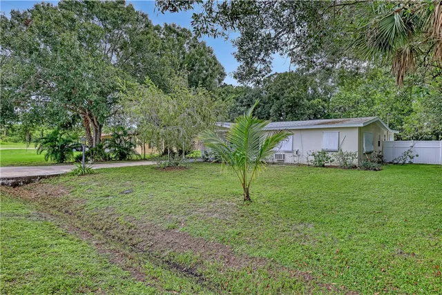 a front view of house with a garden