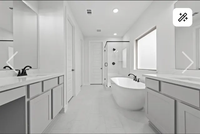 a bathroom with a double vanity sink mirror and bathtub