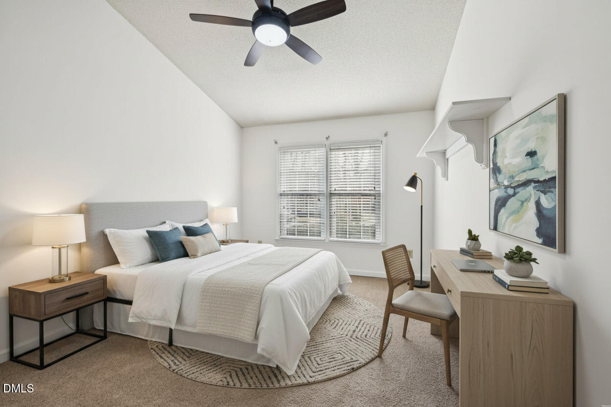 135 Long Shadow Place Durham, NC 27713 - Photo 12 of 23 a bedroom with a bed a couch and a large window