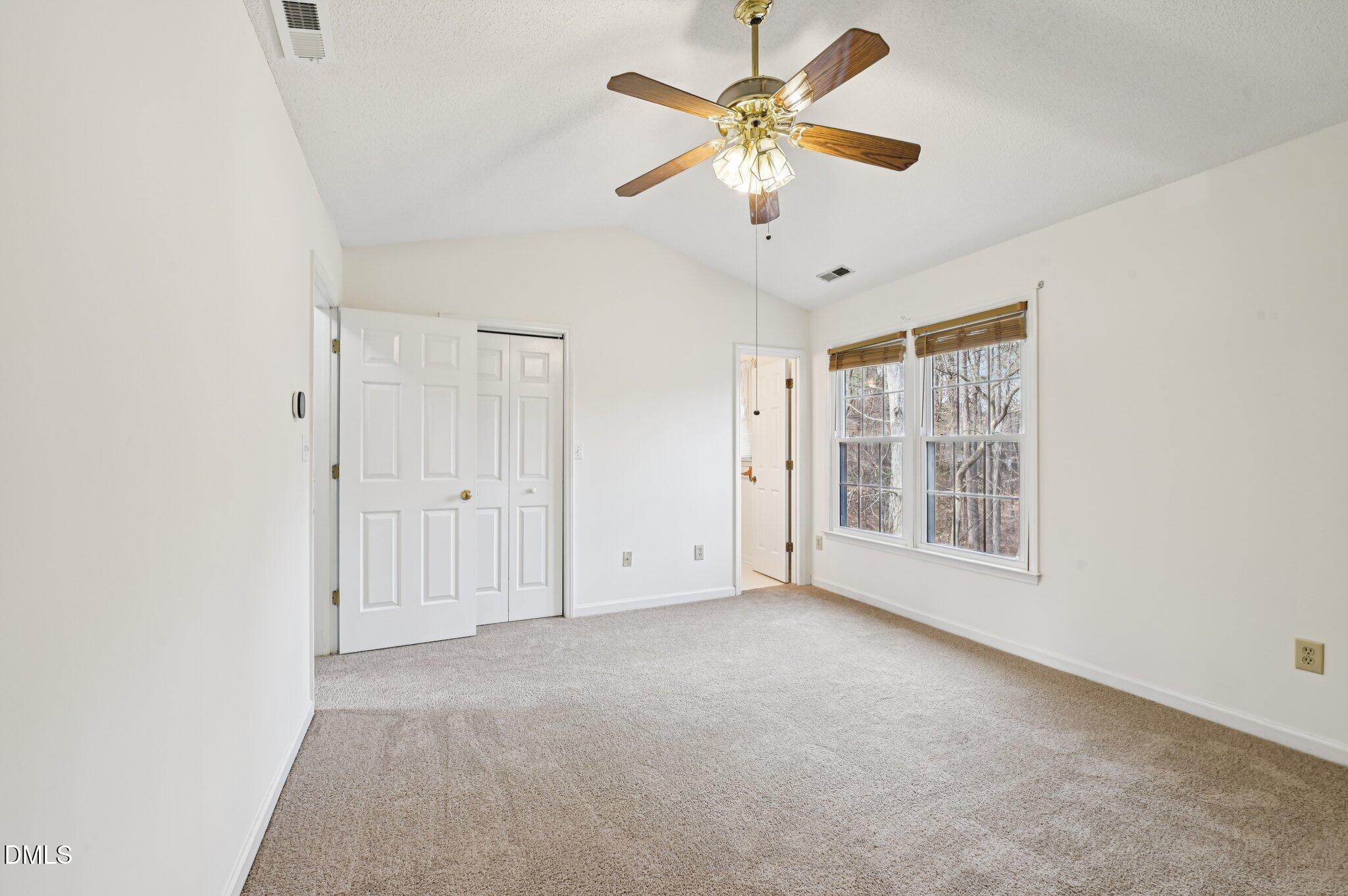 135 Long Shadow Place Durham, NC 27713 - Photo 14 of 23 an empty room with windows and fan
