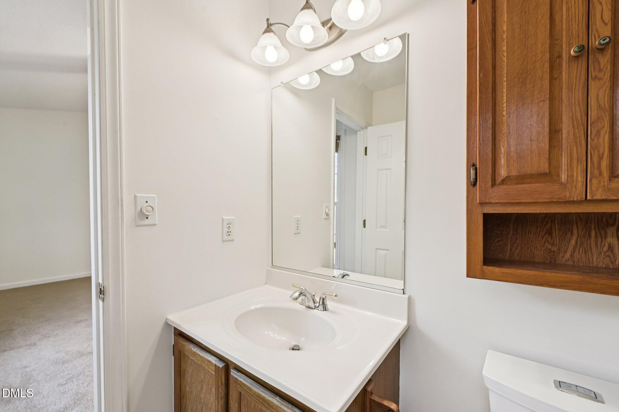 135 Long Shadow Place Durham, NC 27713 - Photo 19 of 23 a bathroom with a sink and a mirror