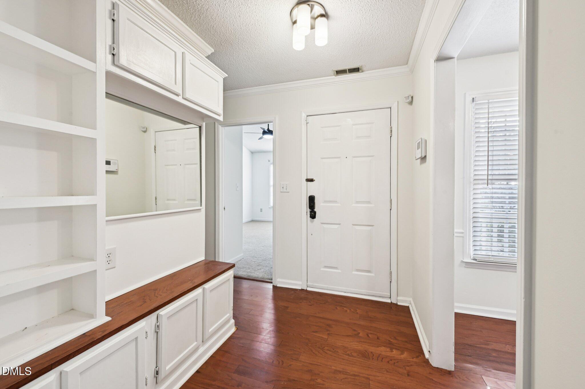 135 Long Shadow Place Durham, NC 27713 - Photo 3 of 23 a hallway with front door and wooden floor