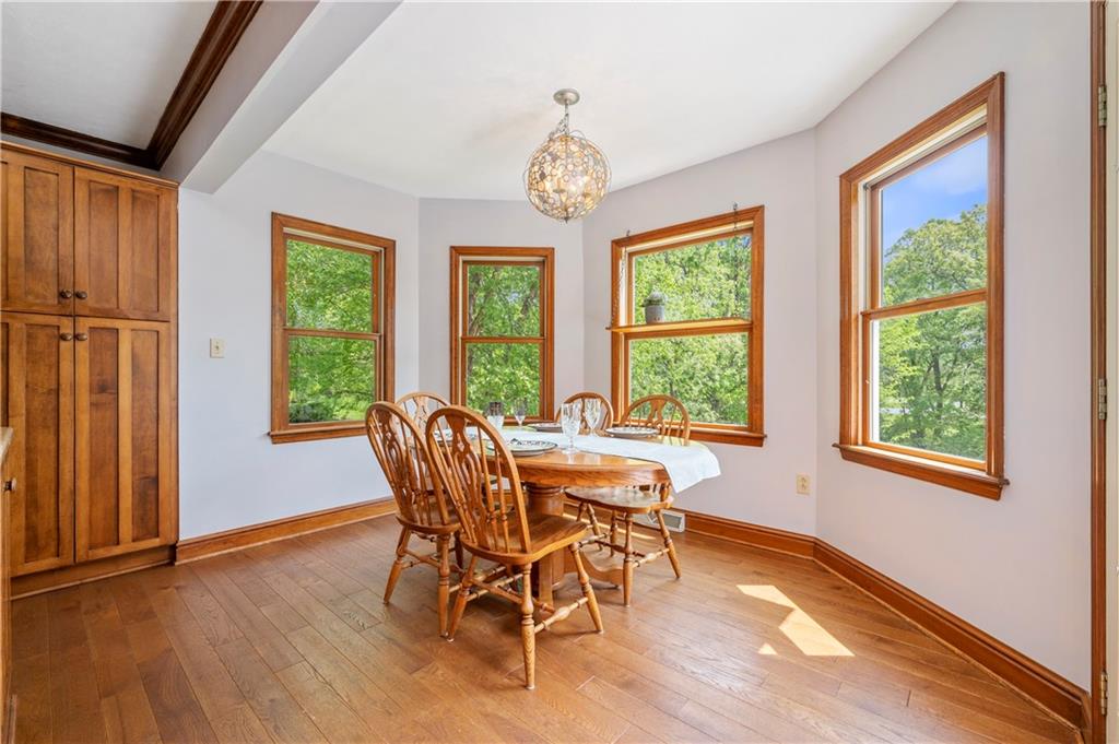 103 Golfview Drive Gibsonia, PA 15044 - Photo 14 of 33 a dining room with furniture a chandelier and wooden floor