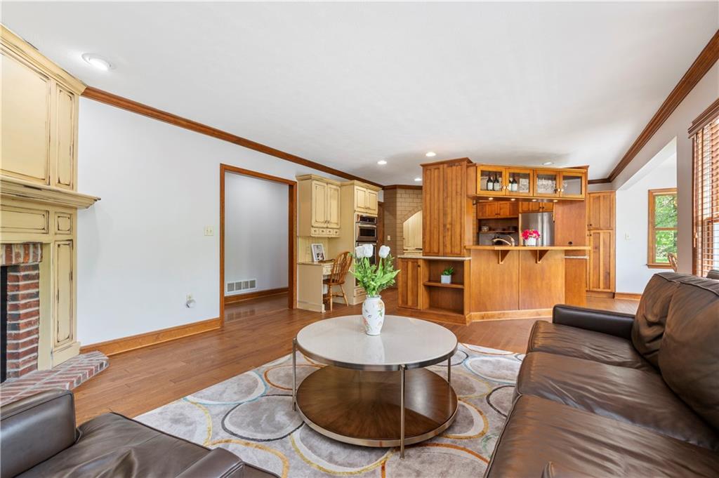 103 Golfview Drive Gibsonia, PA 15044 - Photo 16 of 33 a living room with fireplace furniture dining table and a large window