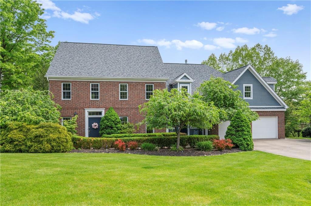 103 Golfview Drive Gibsonia, PA 15044 - Photo 2 of 33 a front view of a house with a yard and garage