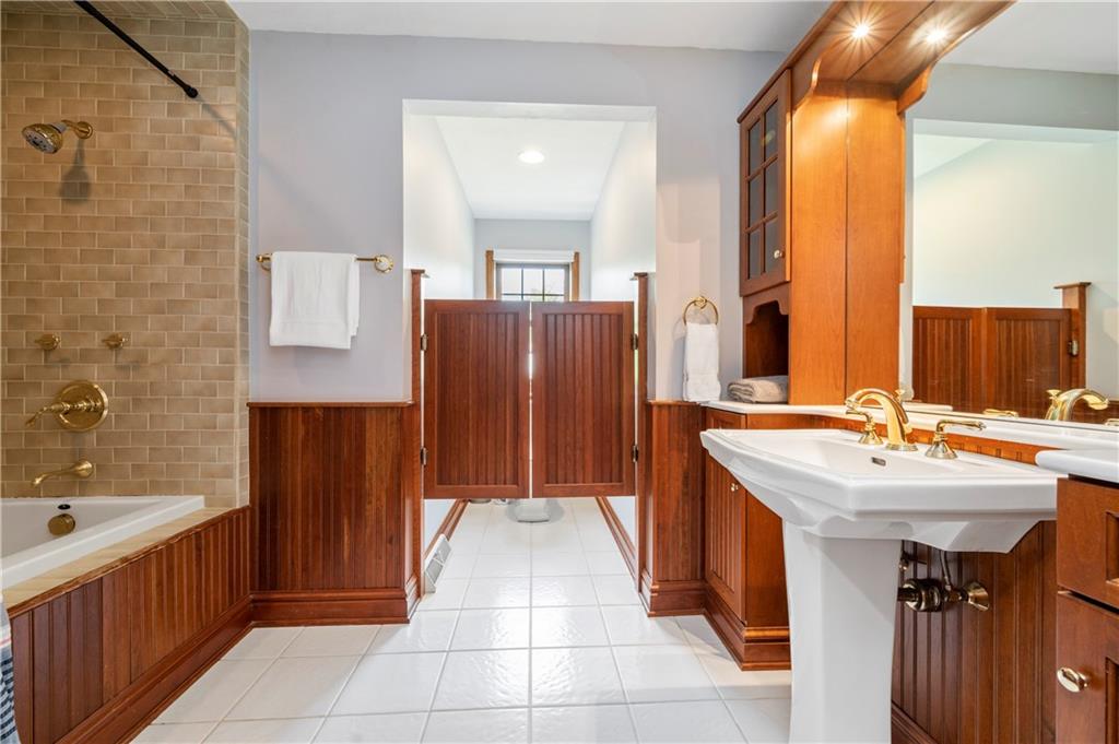 103 Golfview Drive Gibsonia, PA 15044 - Photo 22 of 33 a bathroom with a sink a mirror and a bathtub