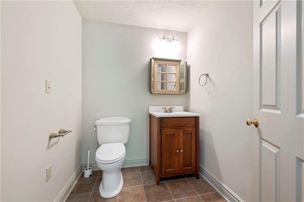 103 Golfview Drive Gibsonia, PA 15044 - Photo 26 of 33 a bathroom with a toilet a sink and mirror