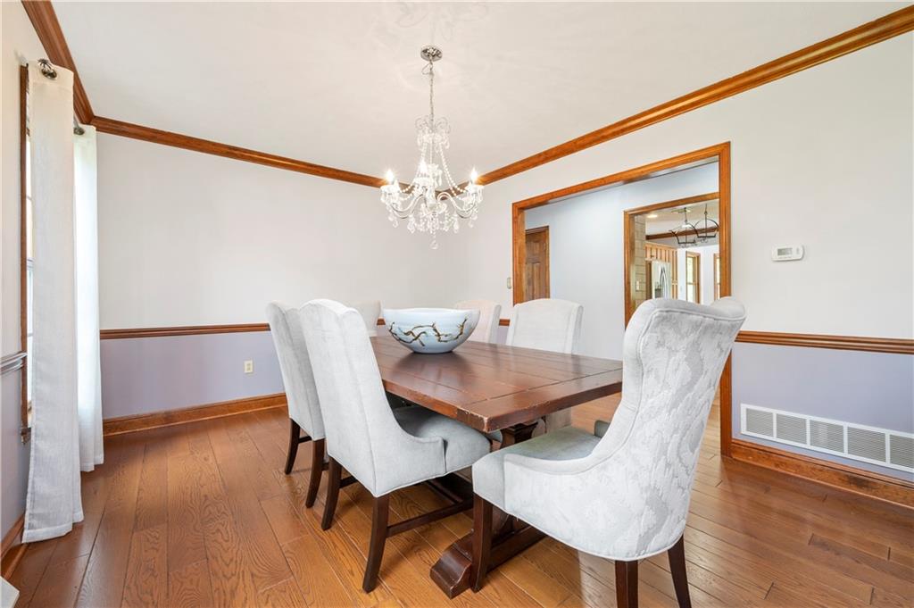 103 Golfview Drive Gibsonia, PA 15044 - Photo 8 of 33 a view of a dining room with furniture wooden floor and chandelier