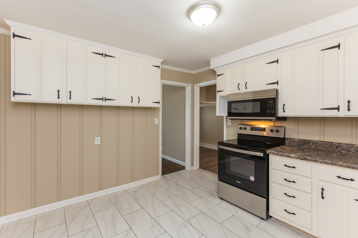 20 Binks Drive Clarksville, TN 37042 - Photo 12 of 35 a kitchen with granite countertop white cabinets and stainless steel appliances