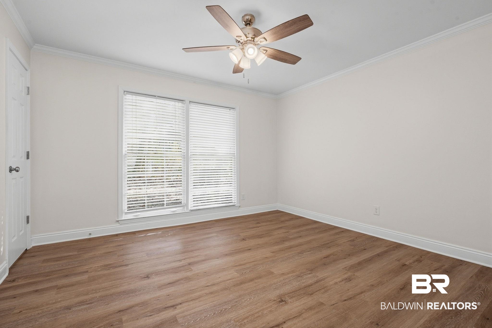 814 Nassau Drive Mobile, AL 36608 - Photo 25 of 44 Empty room with crown molding, wood finished floors, and ceiling fan
