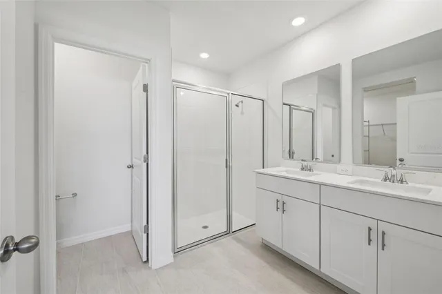a bathroom with a double vanity sink and mirror