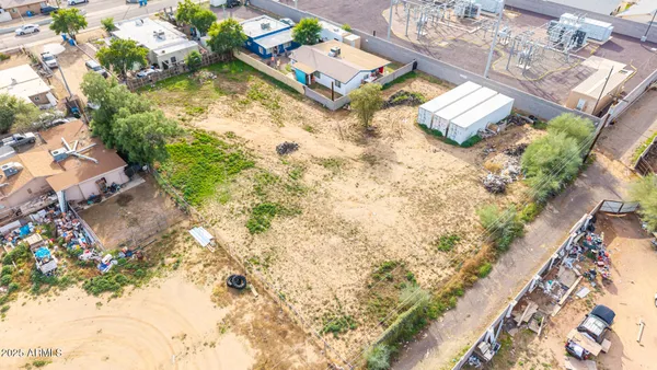 an aerial view of a house with a yard and lake view