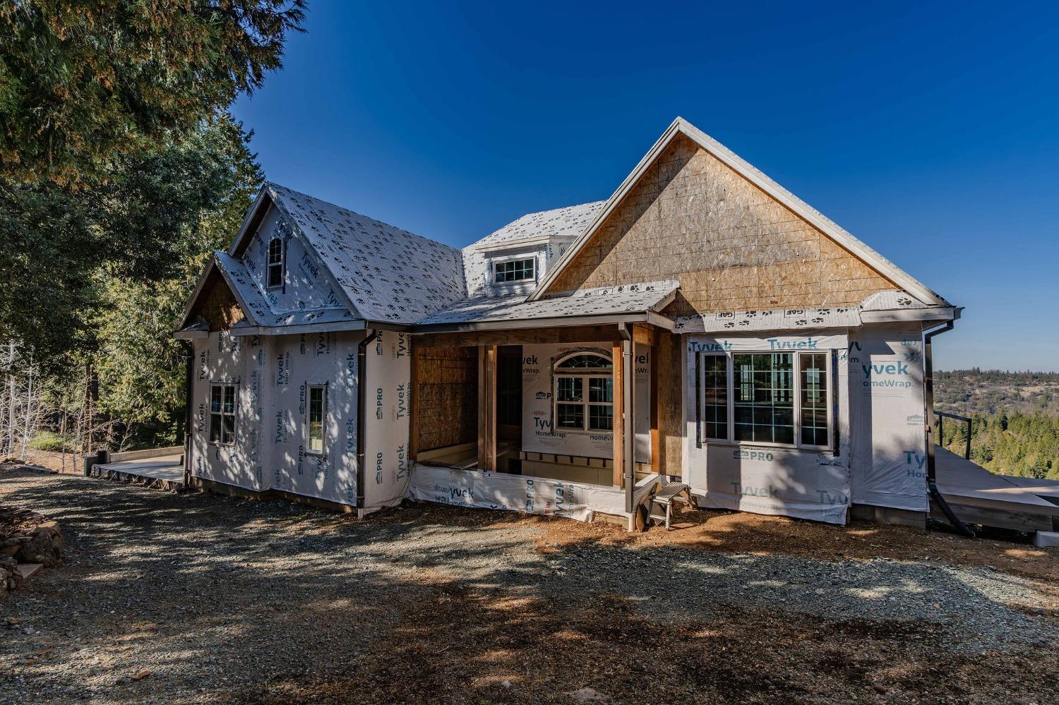 24985 Shake Ridge Road Volcano, CA 95689 - Photo 46 of 92 a front view of a house with a garden and porch