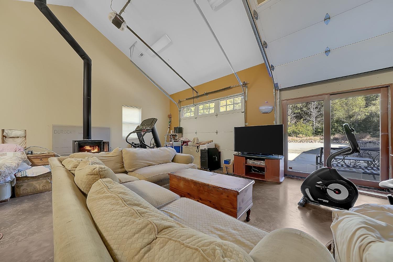 24985 Shake Ridge Road Volcano, CA 95689 - Photo 87 of 92 a living room with furniture and a flat screen tv