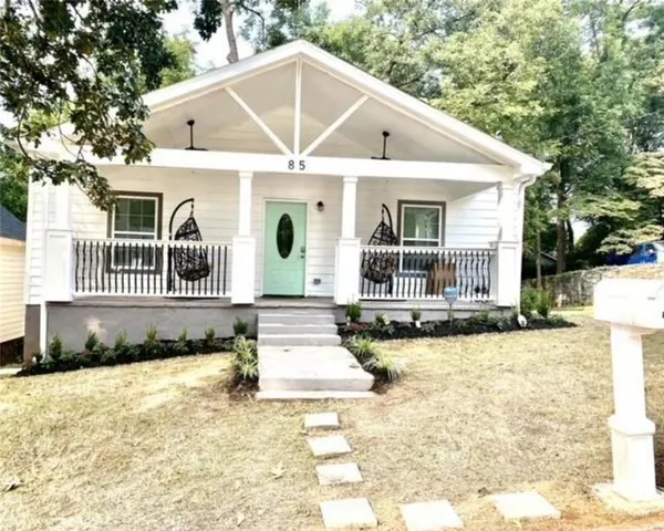 a front view of a house with swimming pool and porch