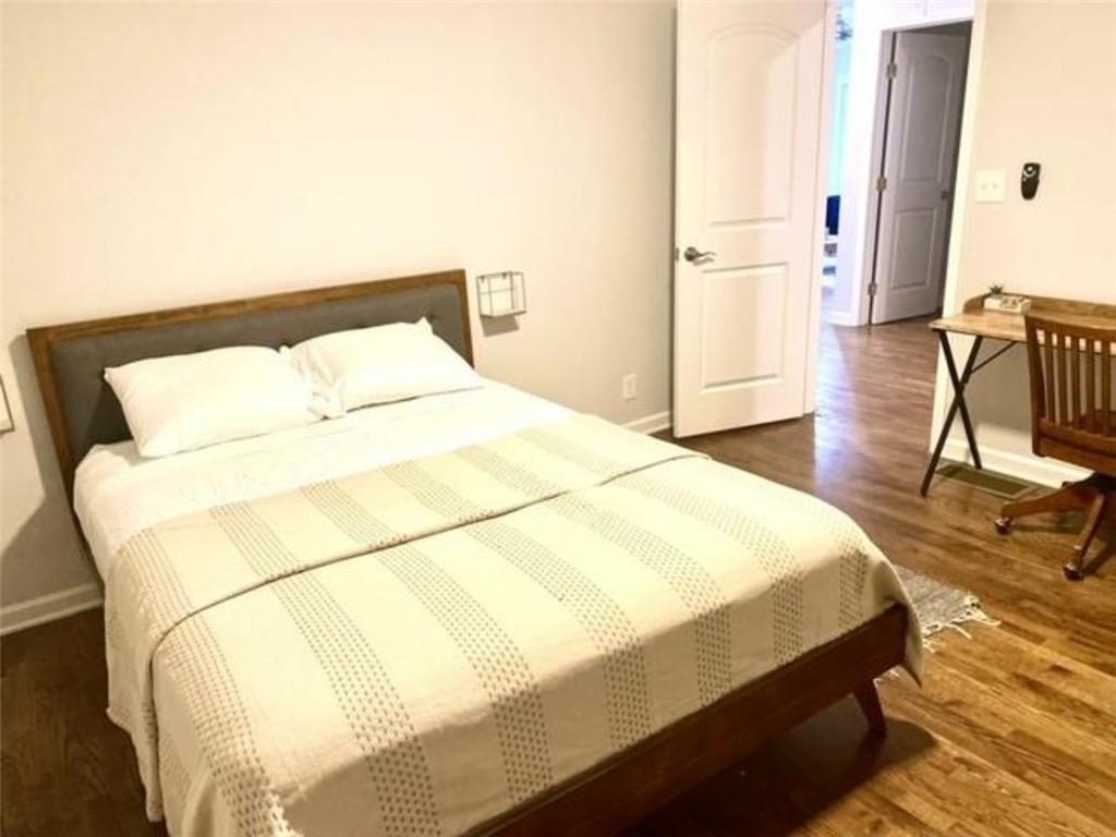 85 Meldon Avenue Southeast Atlanta, GA 30315 - Photo 11 of 23 a bedroom with a bed and wooden floor