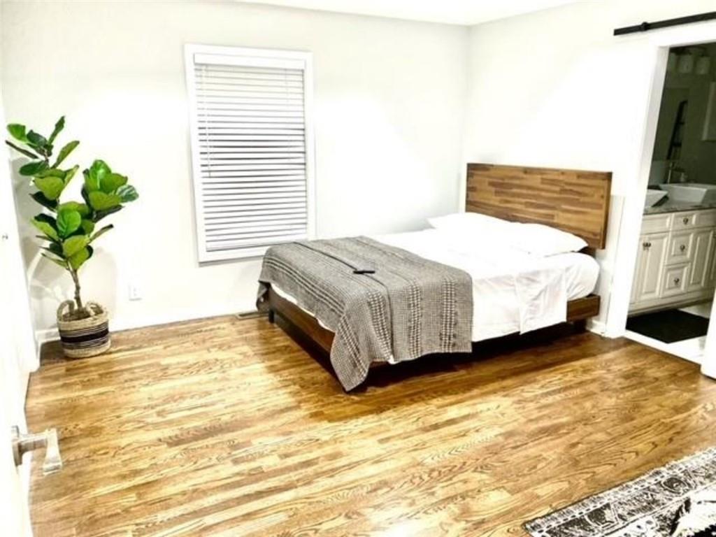 85 Meldon Avenue Southeast Atlanta, GA 30315 - Photo 15 of 23 a spacious bedroom with a bed plant and a window