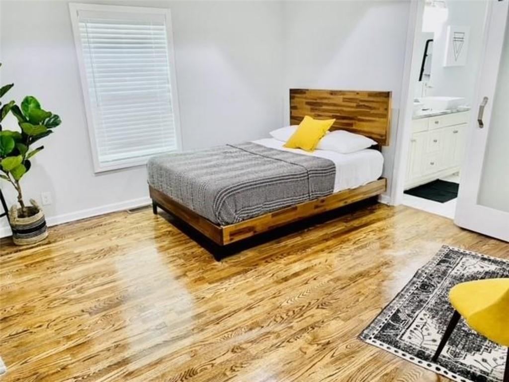 85 Meldon Avenue Southeast Atlanta, GA 30315 - Photo 17 of 23 a bedroom with a bed and a potted plant