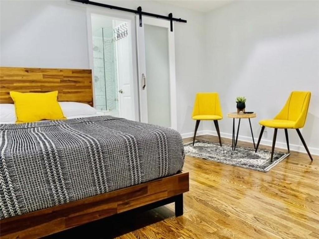 85 Meldon Avenue Southeast Atlanta, GA 30315 - Photo 18 of 23 a bedroom with a bed and chair