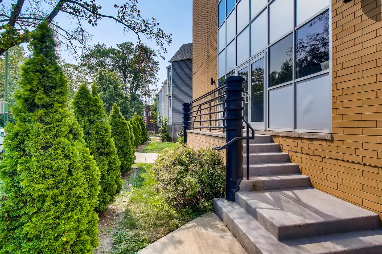 3744 West George Street, Unit D Chicago, IL 60618 - Photo 3 of 30 a view of a pathway of a house with potted plants