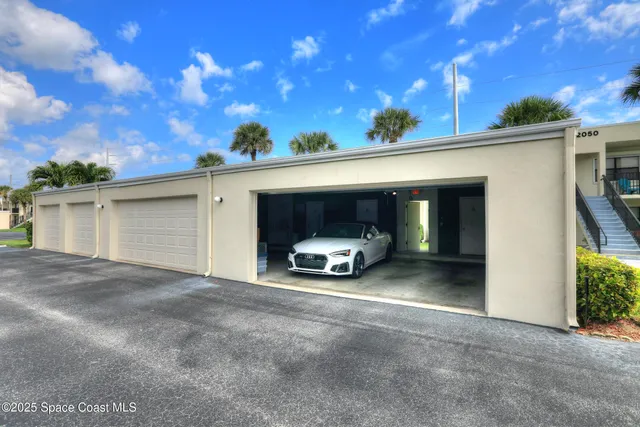 a view of a patio with a table chairs potted plants and outdoor seating